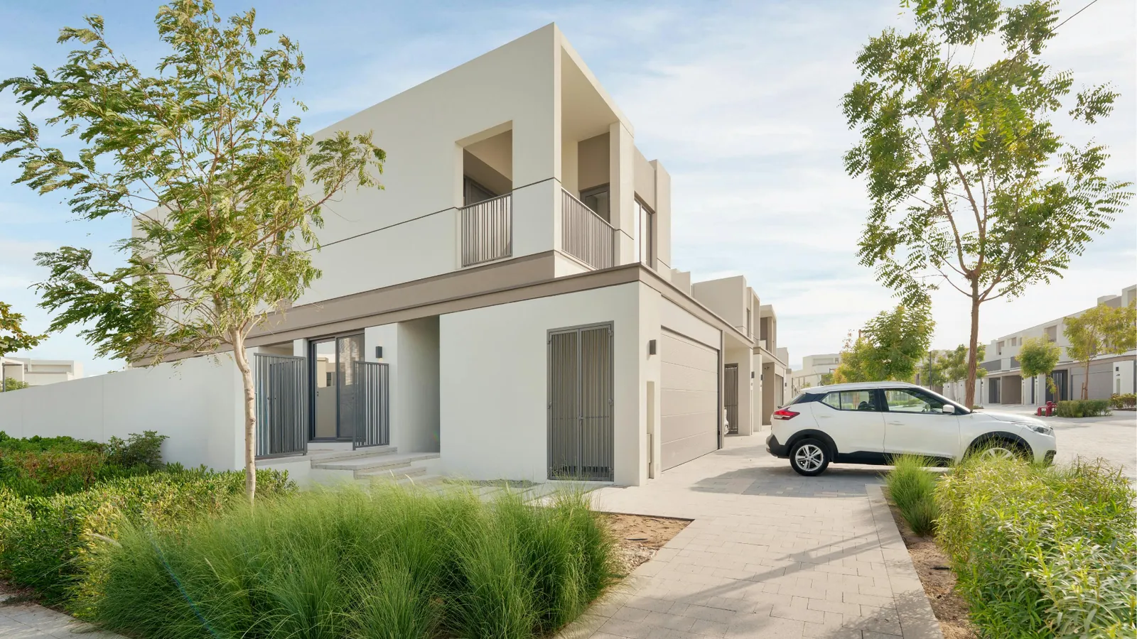 A modern single-family home with a car in the driveway